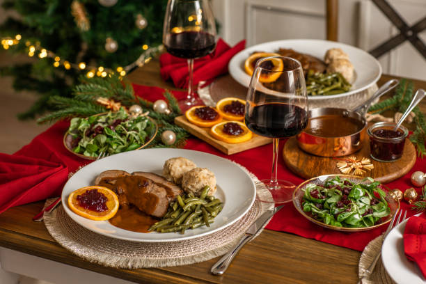 christmas dinner roast beef venison with gravy and cranberries in rustic kitchen home - food stock pictures, royalty-free photos & images