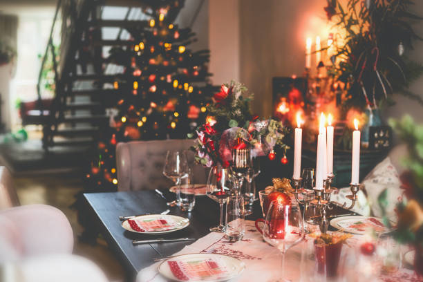 christmas dinner table at festive cozy room background with christmas tree - home decoration stock pictures, royalty-free photos & images