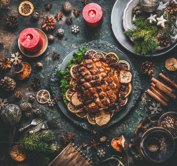christmas dinner table with roasted pork ham , flavors, decoration and candles - food stock pictures, royalty-free photos & images