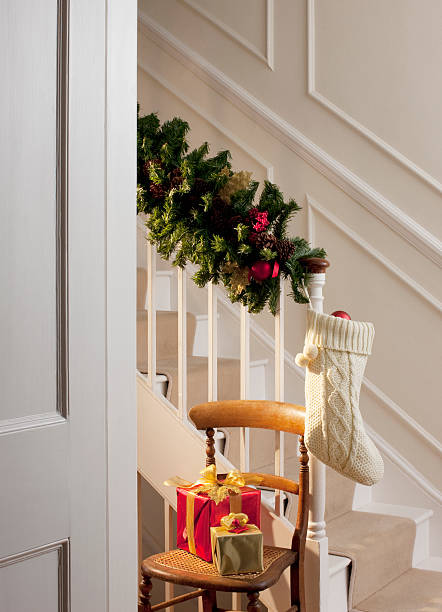 christmas gifts and stocking near staircase - home decoration stock pictures, royalty-free photos & images
