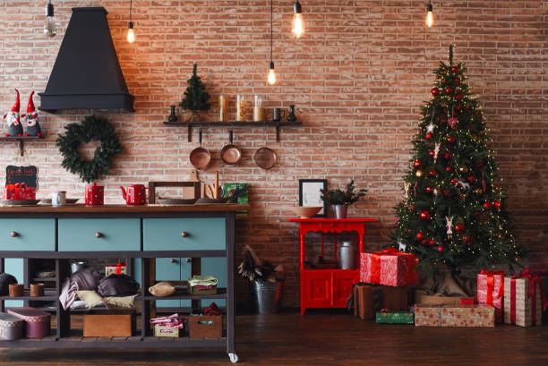 christmas kitchen decor. cooking festive food in the kitchen. new year. christmas. christmas decor. christmas tree. christmas background. christmas home interior decor. holiday. loft style kitchen. - home decoration stock pic