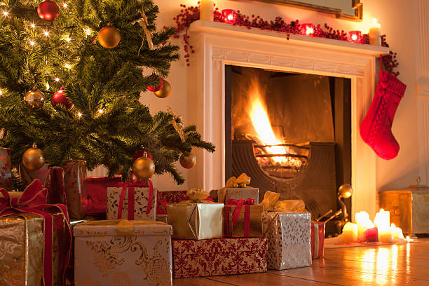 christmas tree and stocking near fireplace - home decoration stock pictures, royalty-free photos & images
