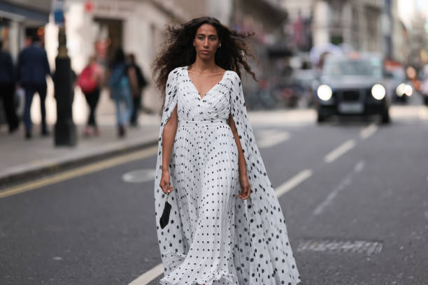 Ciinderella Balthazar was seen wearing black heels and a long white dress with lots of black polka dots as well as a gown, and a black bag with a...