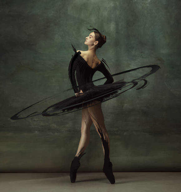 cinematic portrait graceful female ballet dancer posing isolated on dark vintage studio background with drawings. - fashion stock pictures, royalty-free photos & images