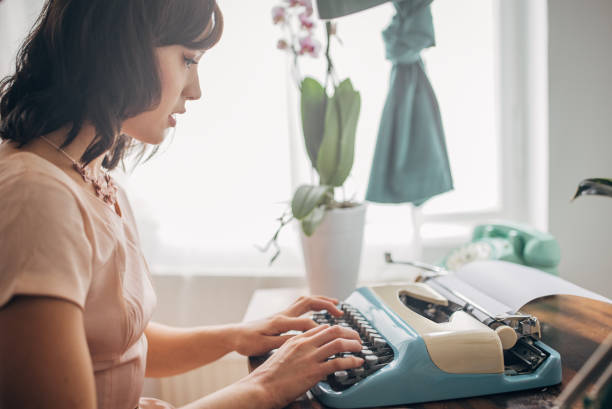 classy woman using typewriter - home decoration stock-fotos und bilder