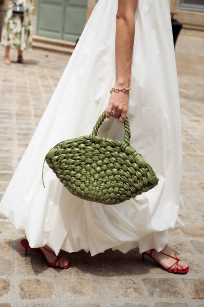Clelia Montali wears a long white maxi dress, and army green bag outside Peet Dullaert during the Haute Couture Fall/Winter 2024/2025 as part of...