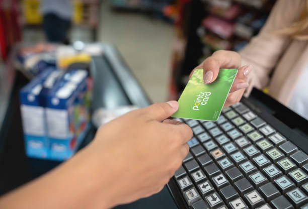 close-up holding a rewards card at the supermarket - food stock pictures, royalty-free photos & images