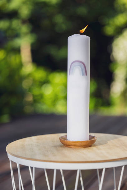 close-up of a baptism candle. garden party, summer festival, birthday party, baptism or wedding. - garden decoration stock pictures, royalty-free photos & images