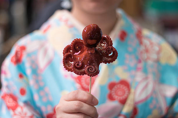 close-up of baby octopus on sticks - food stockfoto's en -beelden