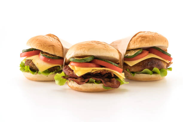 close-up of burgers against white background - junk food stock pictures, royalty-free photos & images