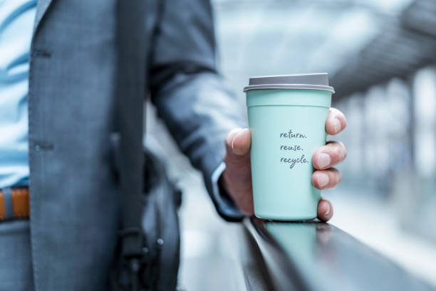 close-up of businessman holding recycable takeaway coffee cup - junk food stock pictures, royalty-free photos & images