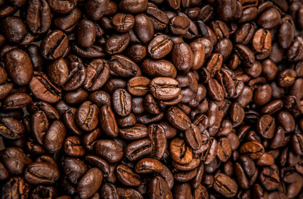 close-up of coffee beans background - coffee stock pictures, royalty-free photos & images
