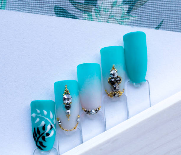 close-up of colorful artificial nails made using nail art in blue colours - nails art stock pictures, royalty-free photos & images