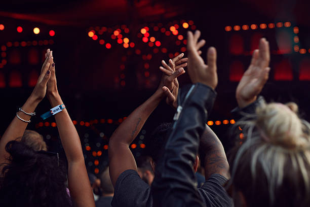 close-up of hands clapping at concert - concert stock pictures, royalty-free photos & images