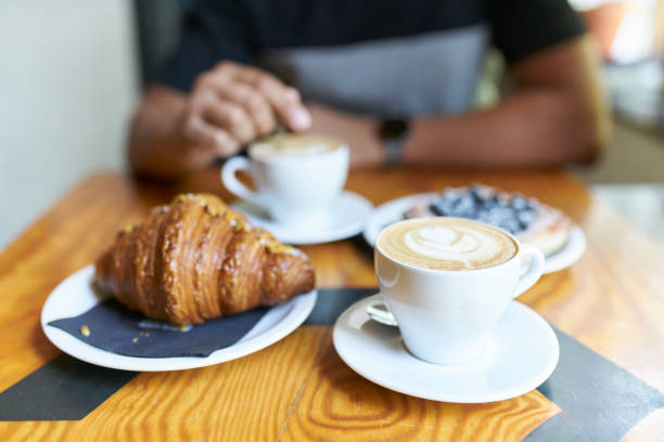 close-up of man having breakfast in a cafe - junk food stock pictures, royalty-free photos & images