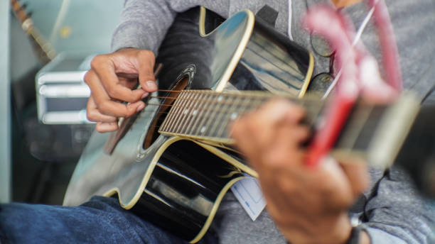 close-up of person playing guitar - concert stock pictures, royalty-free photos & images