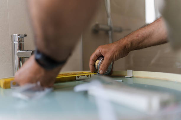 close-up of the hands of a person taking measurements for the bathroom at home. concept of works at home - home decoration stock pictures, royalty-free photos & images