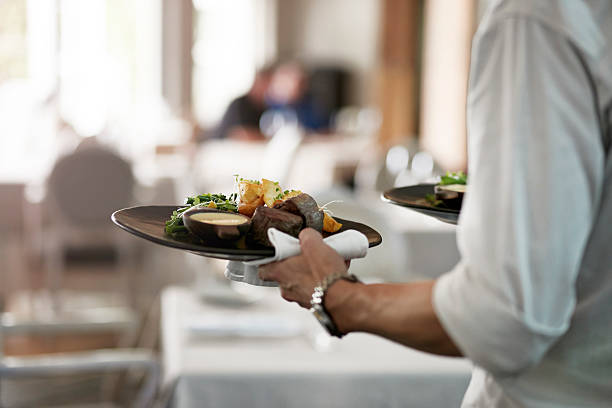 close-up of waiter walkiing with dishes - food stock pictures, royalty-free photos & images