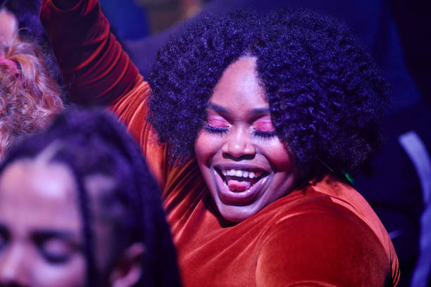 close-up of woman dancing at a music venue. - concert stock pictures, royalty-free photos & images