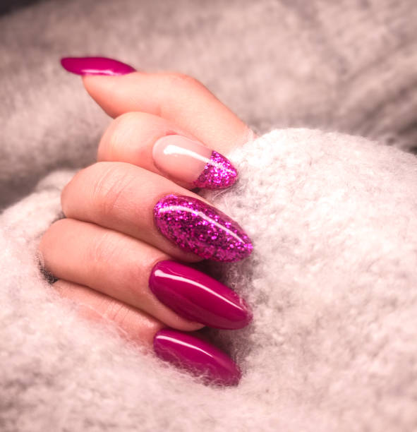 close-up of woman fingers with nail art manicure in pink colour for new years party - nails art stock pictures, royalty-free photos & images