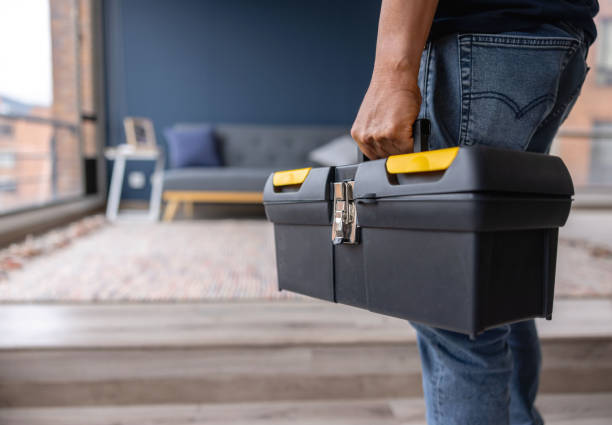 close-up on an electrician carrying a toolbox while working at a house - home decoration stockfoto's en -beelden