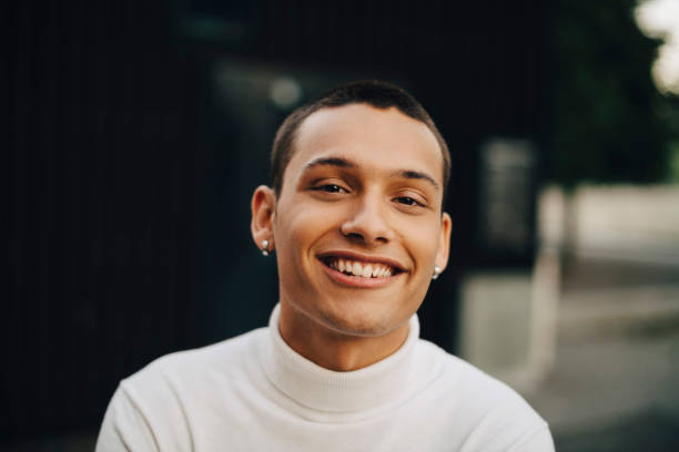 close-up portrait of smiling young man wearing turtleneck - fashion stock pictures, royalty-free photos & images