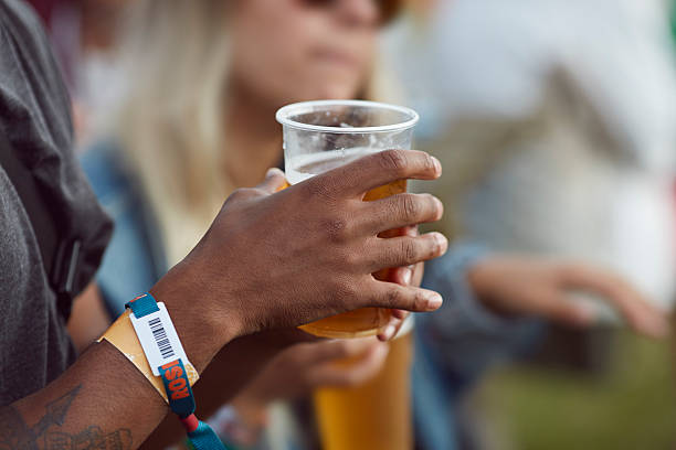 close-up uf hands holding beer, at festival - concert stock pictures, royalty-free photos & images