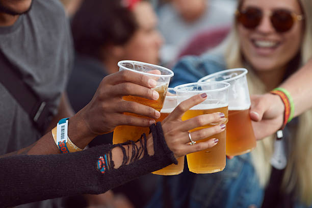 close-up uf hands toasting in beer, at festival - concert stock pictures, royalty-free photos & images