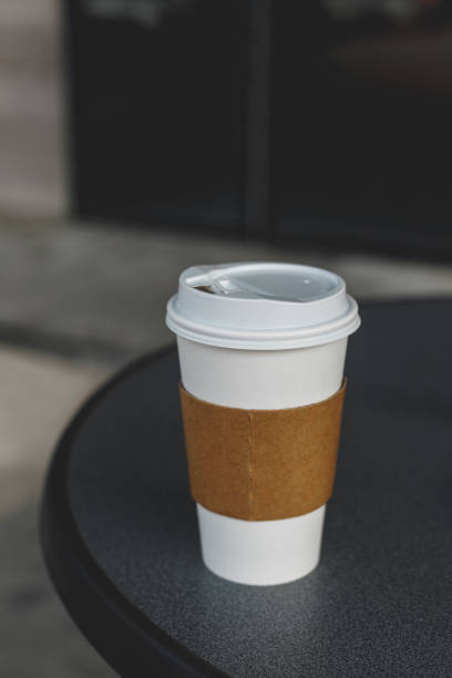 close-up view of paper coffee cup on table - junk food stock pictures, royalty-free photos & images