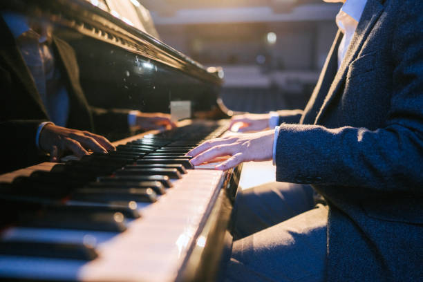 close up asian talented chinese pianist finger playing performing on stage - concert stock pictures, royalty-free photos & images