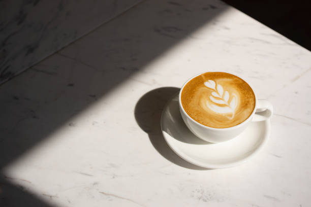 close up cappuccino cup with lighting and copy space - coffee stock pictures, royalty-free photos & images