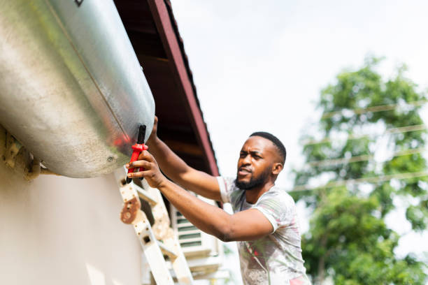 close up man using tools trying to fix hot water geyser - home decoration stock pictures, royalty-free photos & images