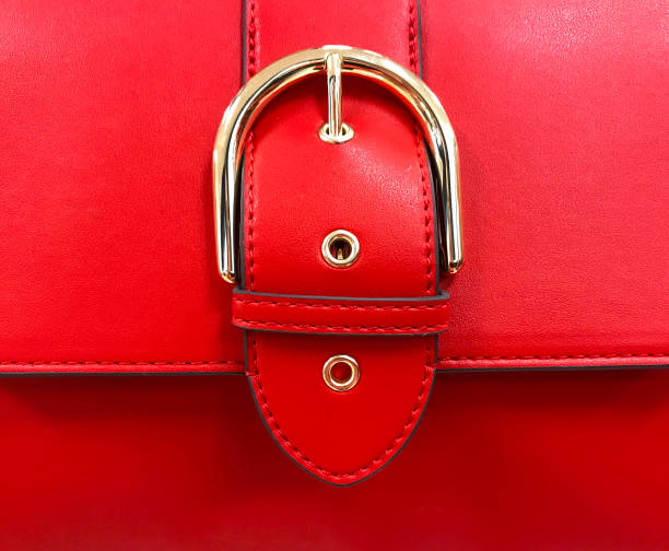 close up of a red purse detail showing belt buckle design on flap - fashion stock pictures, royalty-free photos & images