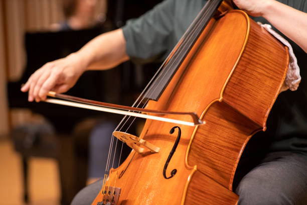 close up of cellist playing at classical concert - concert stock pictures, royalty-free photos & images