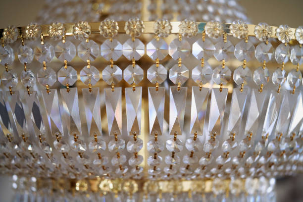 close up of crystal pieces of a chandelier and some golden pieces. a chandelier is zoomed to see its crystal made parts. - home decoration stock pictures, royalty-free photos & images