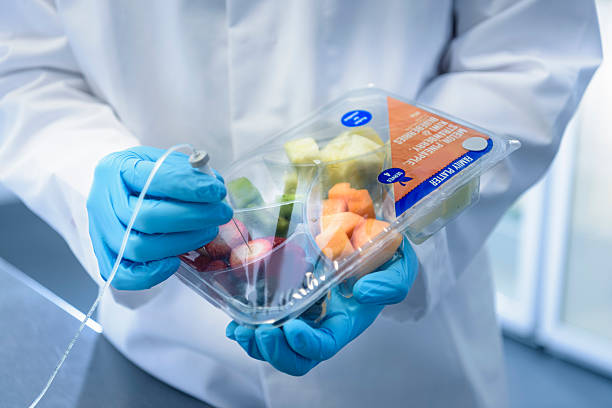 close up of scientist inspecting food for freshness in laboratory in food packaging printing factory - food stock pictures, royalty-free photos & images