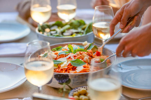 close up of serving spaghetti bolognese on a table at sunset. - food stock pictures, royalty-free photos & images