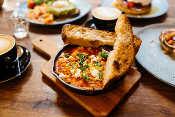close up of shakshuka served in cooking pan on the table in cafe - food stockfoto's en -beelden