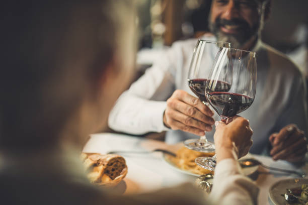 close up of toasting with wine in a restaurant! - food stock pictures, royalty-free photos & images