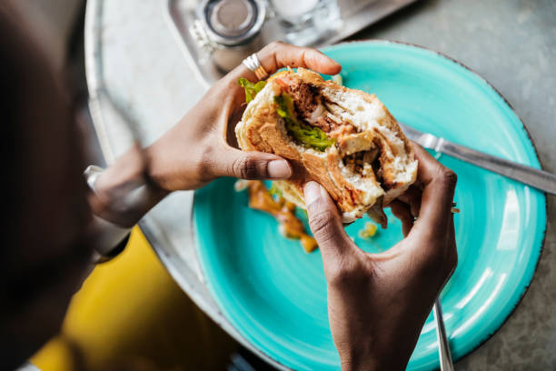 close up of woman eating vegan meal - food stockfoto's en -beelden