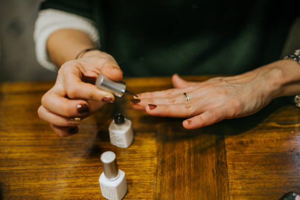 close up of woman with long, slender fingers, paints her nails at home - nails art stock pictures, royalty-free photos & images