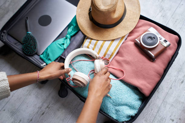 close up photo of black woman'l packing. - travel stock pictures, royalty-free photos & images