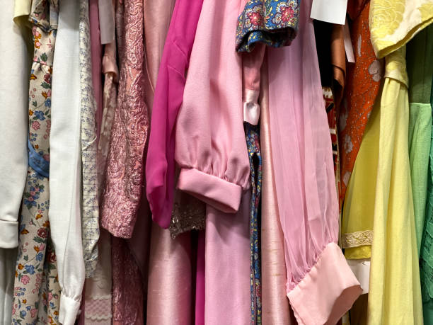 clothing rack of vintage clothing at antique flea market - fashion stock pictures, royalty-free photos & images