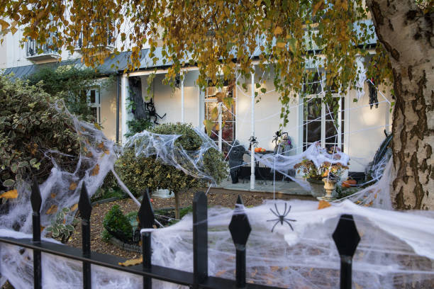 Cobwebs and other decorations are arranged around a garden to mark Halloween on 31 October 2020 in Windsor, United Kingdom. Halloween celebrations,...