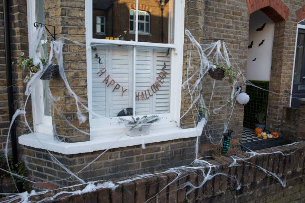 Cobwebs and pumpkins are arranged around a garden to mark Halloween on 31 October 2020 in Windsor, United Kingdom. Halloween celebrations, and in...