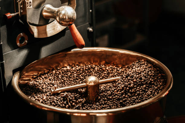 coffee beans being cooled after being roasted from a coffee roaster machine - coffee stock pictures, royalty-free photos & images