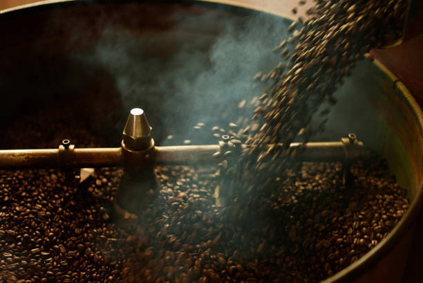 coffee beans dark roast pouring to cooling batch after finish process roasting coffee beans - coffee stockfoto's en -beelden