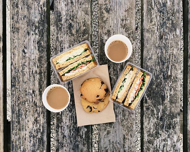 coffee, sandwiches and cookies on the old table - junk food stock pictures, royalty-free photos & images