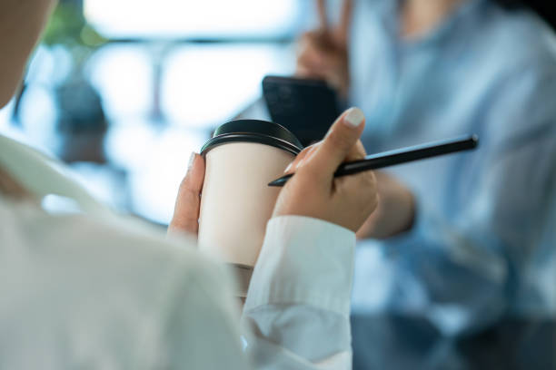 coffee shop, baristas taking order and writing customer name on paper cup for ordering. - junk food stock pictures, royalty-free photos & images