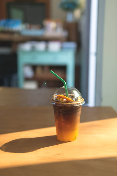 cold drink in disposable cup, espresso coffee with orange juice drink. - junk food stock pictures, royalty-free photos & images